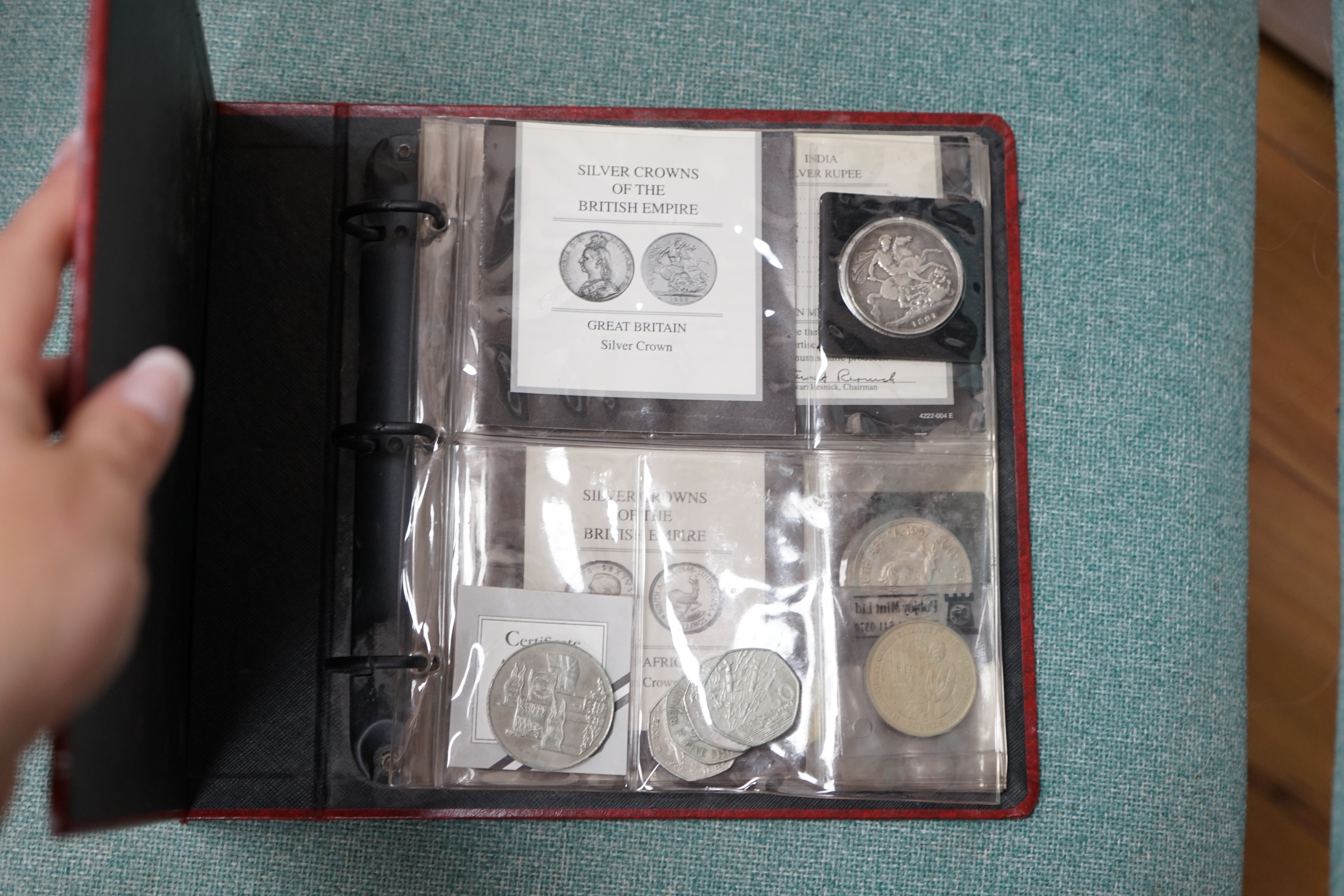 An album of coins and other loose coins, including an 1891 silver crown, 1901 silver trade dollar, commemorative 50p pieces, etc. Condition - fair.